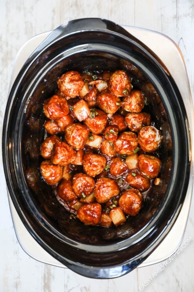 How to make Hawaiian Meatballs in a Crockpot. Step 3: Mix the meatballs with the sauce. Cover the crockpot and cook.