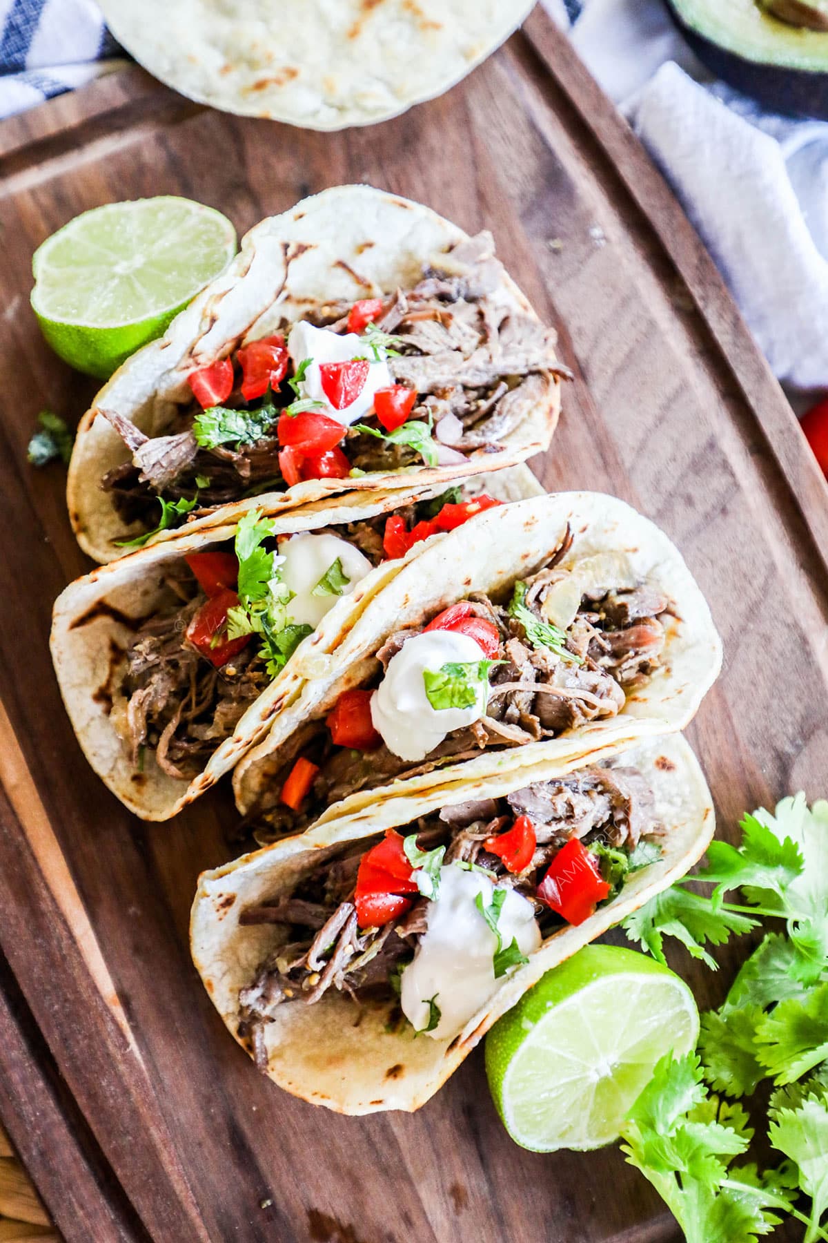 Slow Cooker Shredded Mexican Beef used to make tacos for easy dinner.