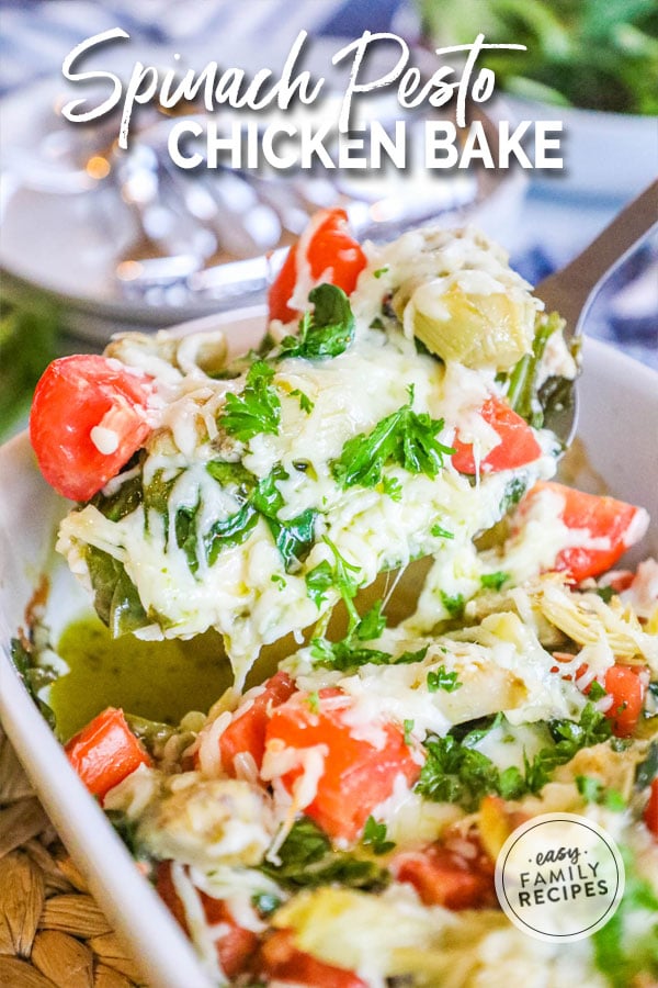 Baked Pesto chicken being lifted out of the pan