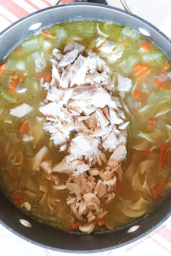 How to makechicken noodle soup with rotisserie chicken step 3. Remove the rotisserie chicken and add noodles. Pull the meat from the chicken and stir it back in.