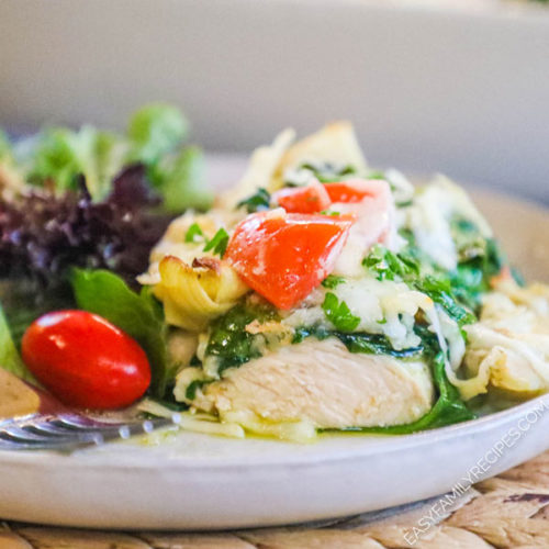 Baked Pesto Chicken on a Plate with a bite cut out.