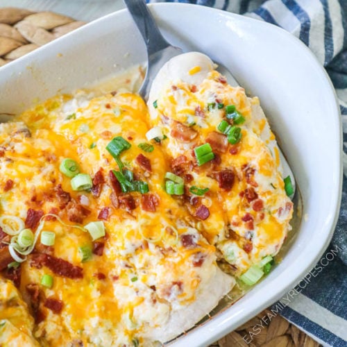 Million Dollar Baked Chicken lifted from casserole dish with spatula