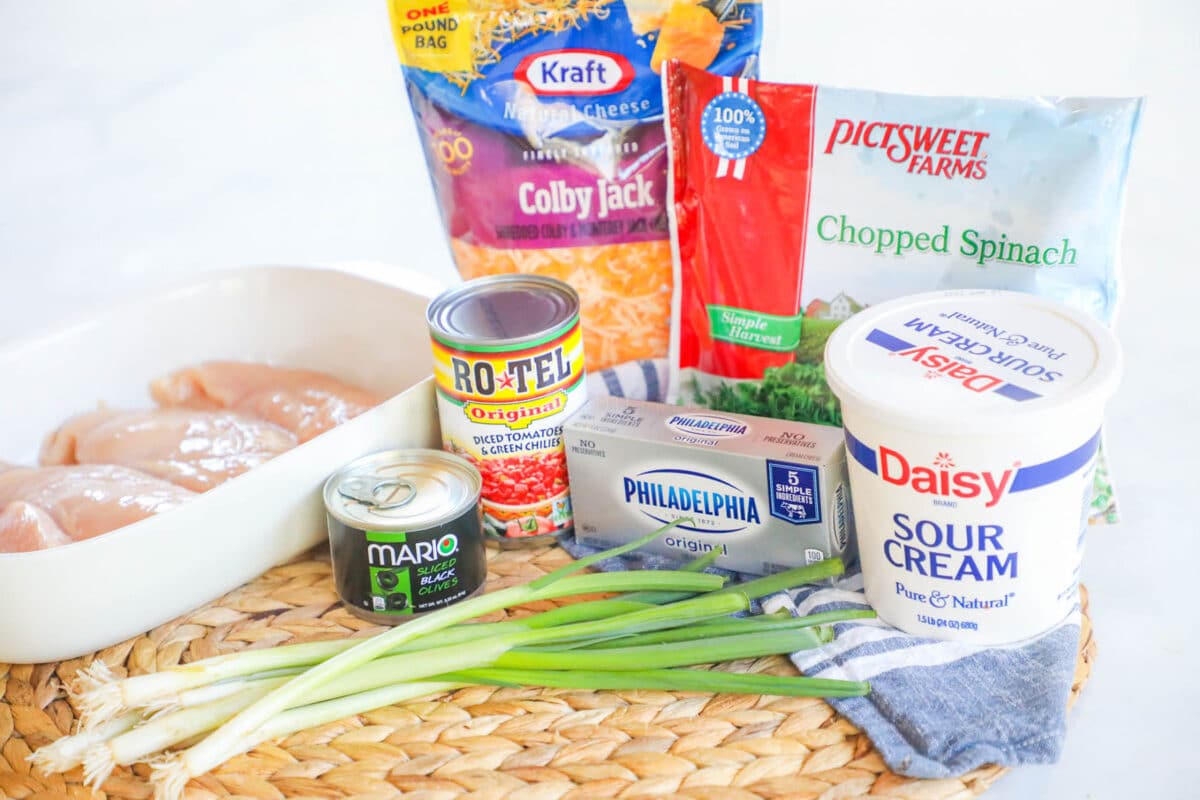Ingredients to make mexican spinach chicken bake - chicken, spinach, rotel tomatoes, green onions, cream cheese, colby jack cheese