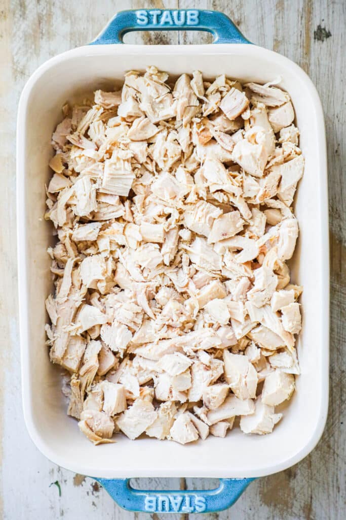 Step 1 add cooked, chopped chicken to a casserole dish