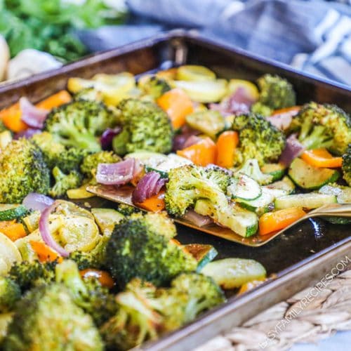 Cajun seasoned veggies being lifted with a spatula