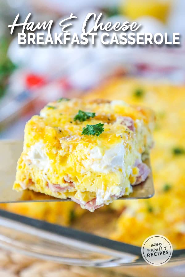 Spatula lifting a slice of ham and cheese breakfast casserole