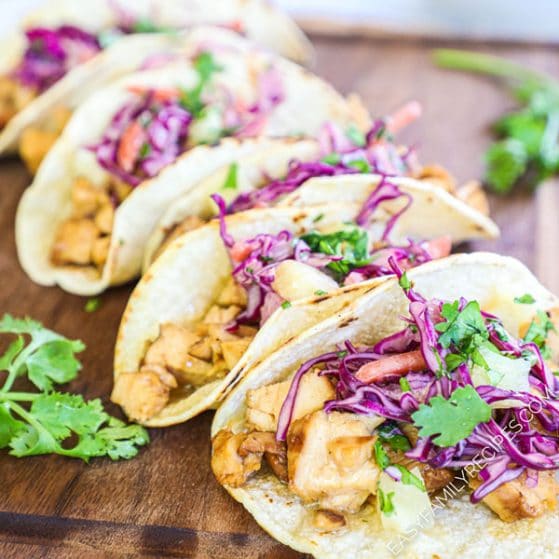 Grilled Hawaiian Chicken Tacos topped with pineapple coleslaw and garnished with cilantro