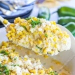 Lifting Mexican Street Corn Chicken Bake out of baking dish.