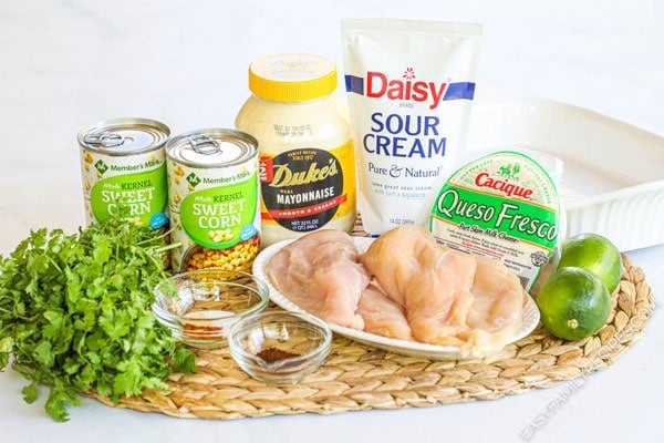 Ingredients to make Mexican Street Corn Chicken including chicken breast, mayo, sour cream, corn, cheese, lime, cilantro