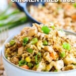 Chicken fried rice in a bowl with skillet in background