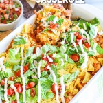 Scooping Chicken Taco Casserole out of baking dish