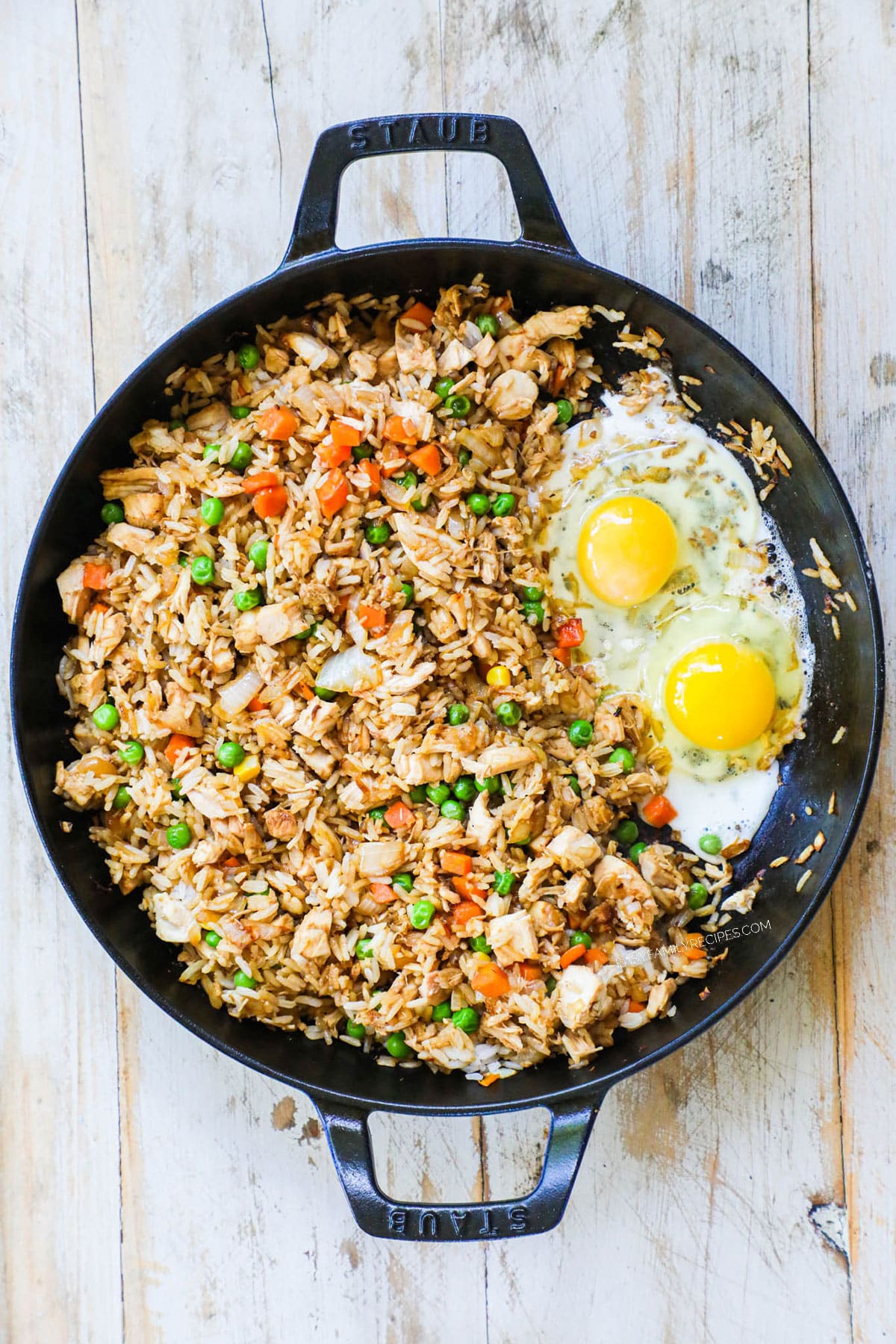 Step 3 for chicken fried rice - pusg everything to the side and add the egg, scrambling and cooking until done