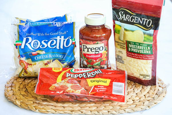 Ingredients for making Ravioli Lasagna including frozen ravioli, marinara sauce, pepperoni, and cheese