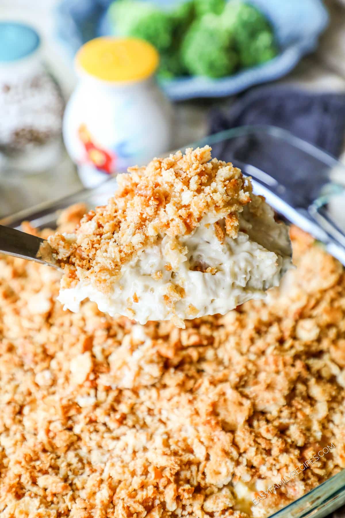 Serving creamy chicken rice casserole with ritz cracker topping with a spoon.