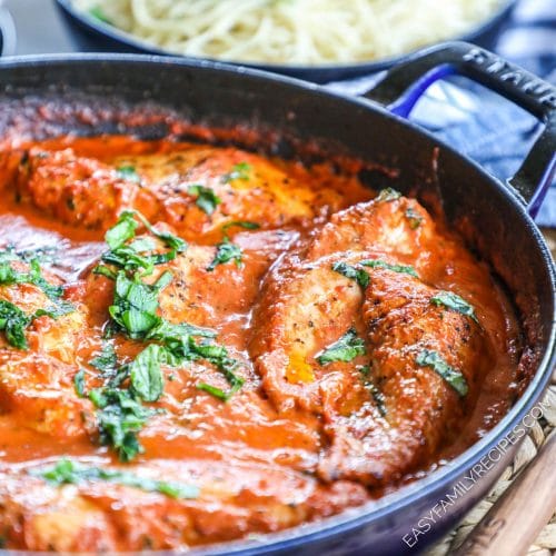 Chicken in tomato basil sauce simmering in a skillet