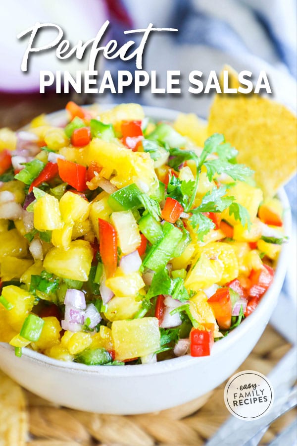 Fresh Pineapple Salsa in a bowl with red pepper, cilantro, onion and lime