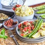 Bruschetta Chicken with a crispy mozzarella crust served with roasted asparagus and bacon mashed potatoes