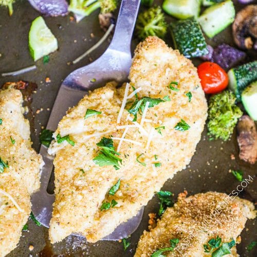 Healthy Baked Chicken Cutlet being lifted from the pan with a spatula