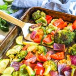 Mexican Roasted Vegetables being lifted from pan after baking