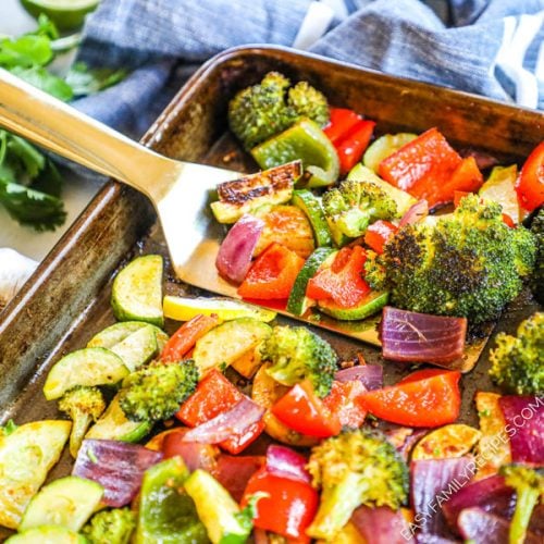 Mexican Roasted Vegetables being lifted from pan after baking