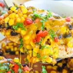 Santa Fe Chicken Bake recipe prepared and being lifted from the baking dish.
