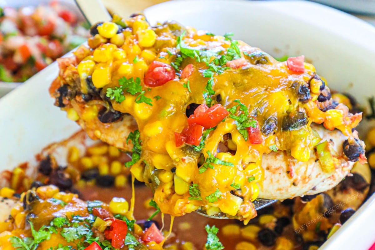 Santa Fe Chicken Bake recipe prepared and being lifted from the baking dish.