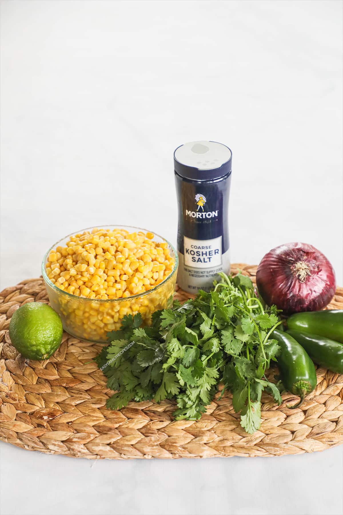 Ingredients to make chipotle corn salsa - corn, salt, cilantro, onion and lime