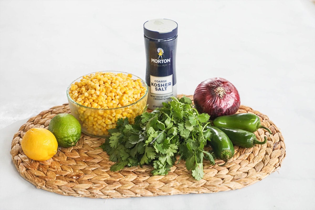 Ingredients to make chipotle corn salsa - corn, salt, cilantro, onion and lime