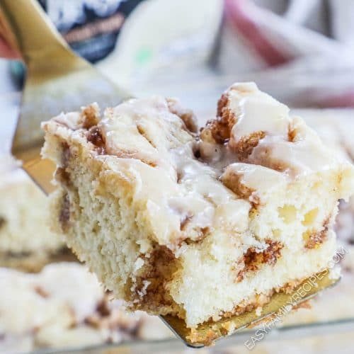 slice of cinnamon swirl cake showing the cinnamon swirl in the middle of the vanilla cake