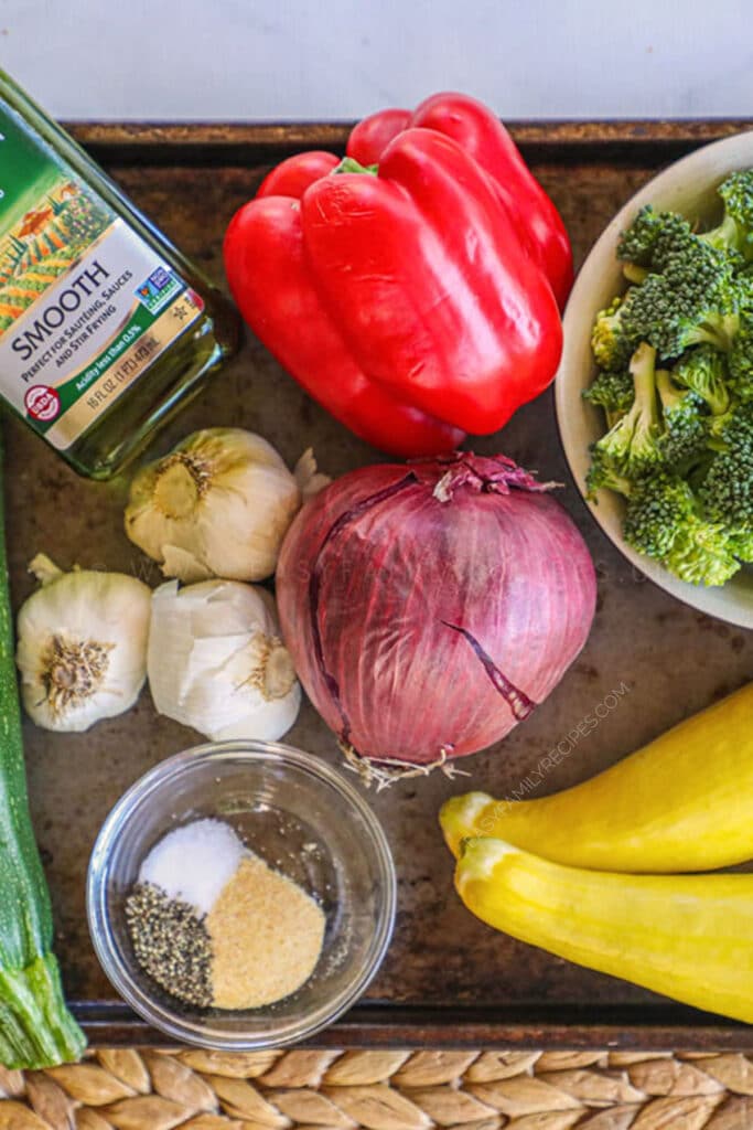 INgredients for garlic roasted veggies. Peppers, broccoli, squash, garlic, olive oil, onion and seasonings