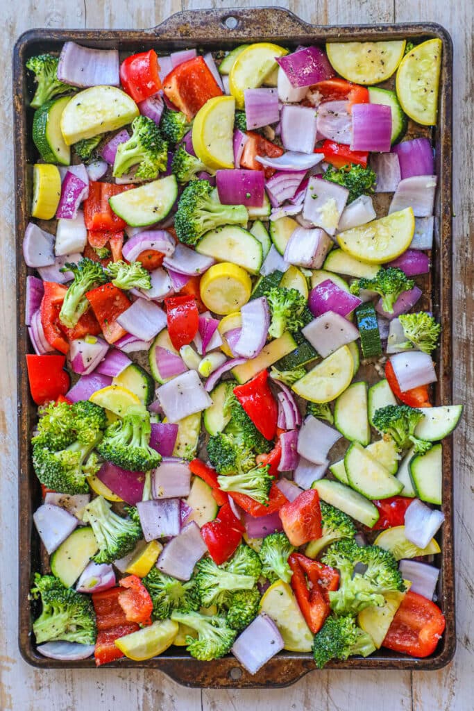 How to make roasted vegetables step 2 - add olive oil and seasonings to veggies. mix well