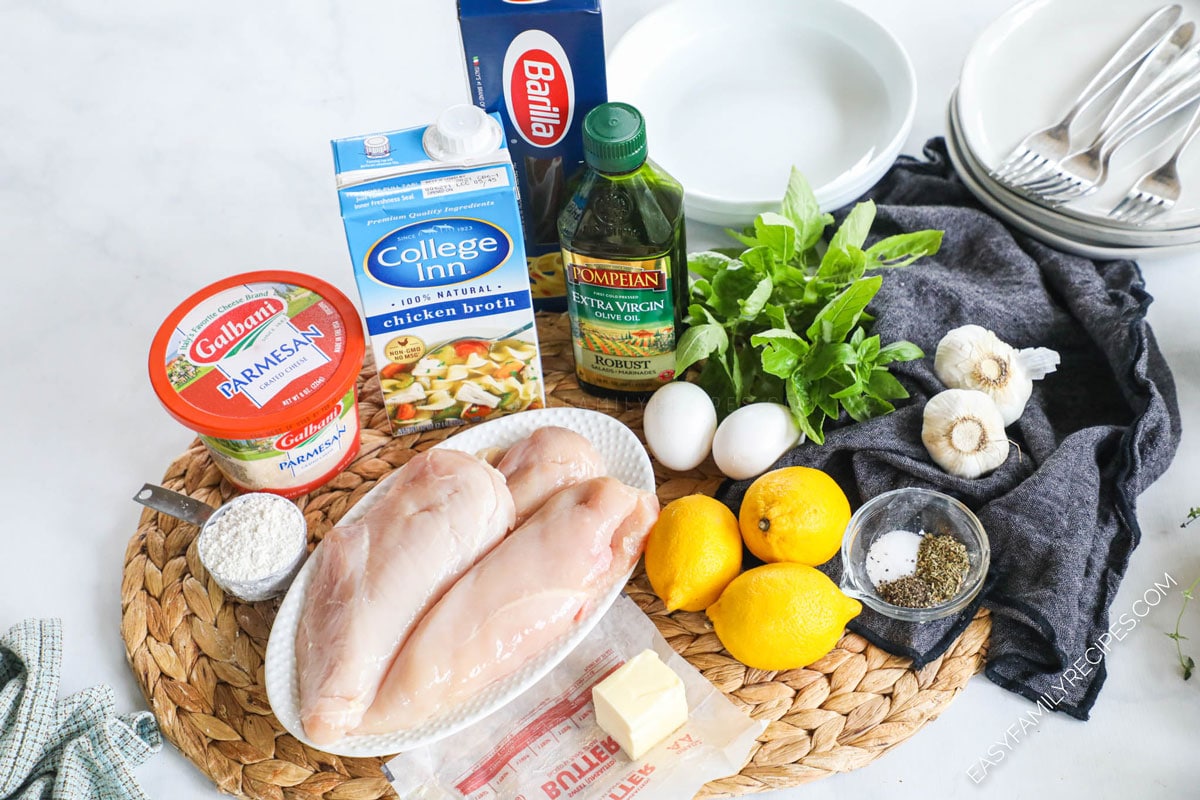 Ingredients for lemon basil chicken including chicken breast, parmesan, butter, chicken broth, fresh basil, lemon and garlic