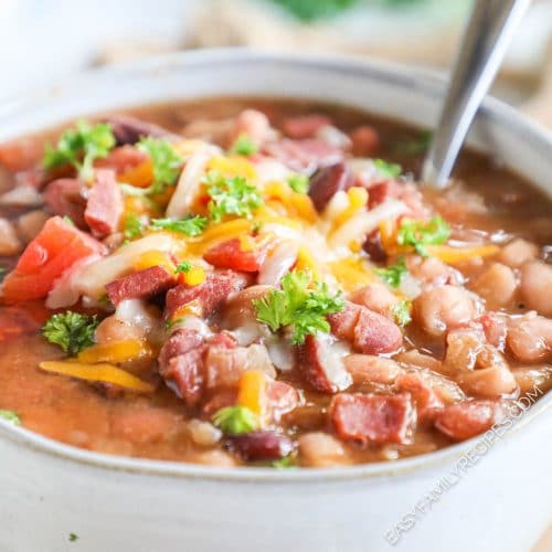 Easy 15 bean soup served in a bowl and garnished with cheese