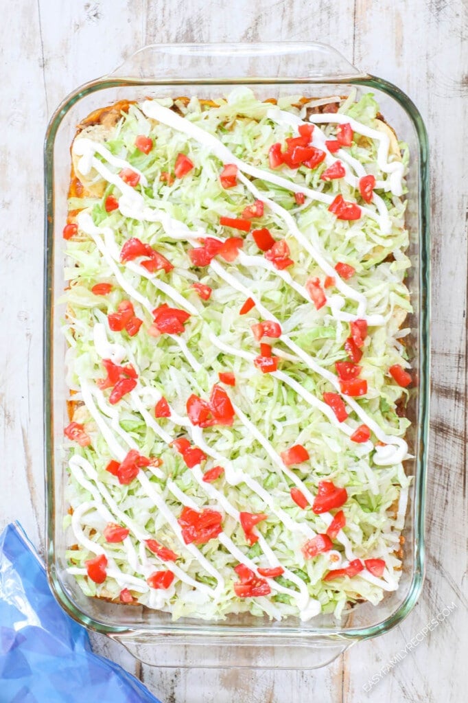 How to make Taco Casserole Step 4: Top with lettuce, tomato, and sour cream.