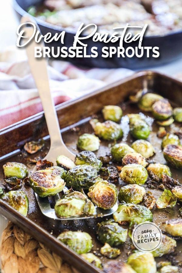 Crispy roasted brussels sprouts out of the oven being served with a spatula