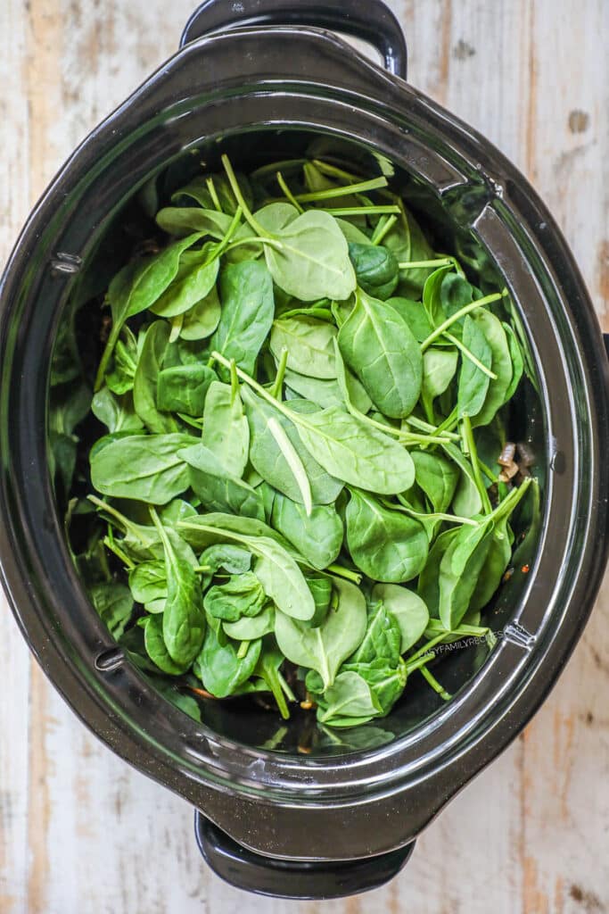 STep 3 Greek Chicken Remove the chicken. Mix the spinach into the vegetables and close the lid for 5-10 minutes or until it wilts.