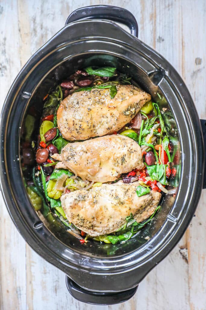 Step 4 Greek chicken - Lay the chicken back on top, squeeze fresh lemon juice over everything, and top with feta cheese.
