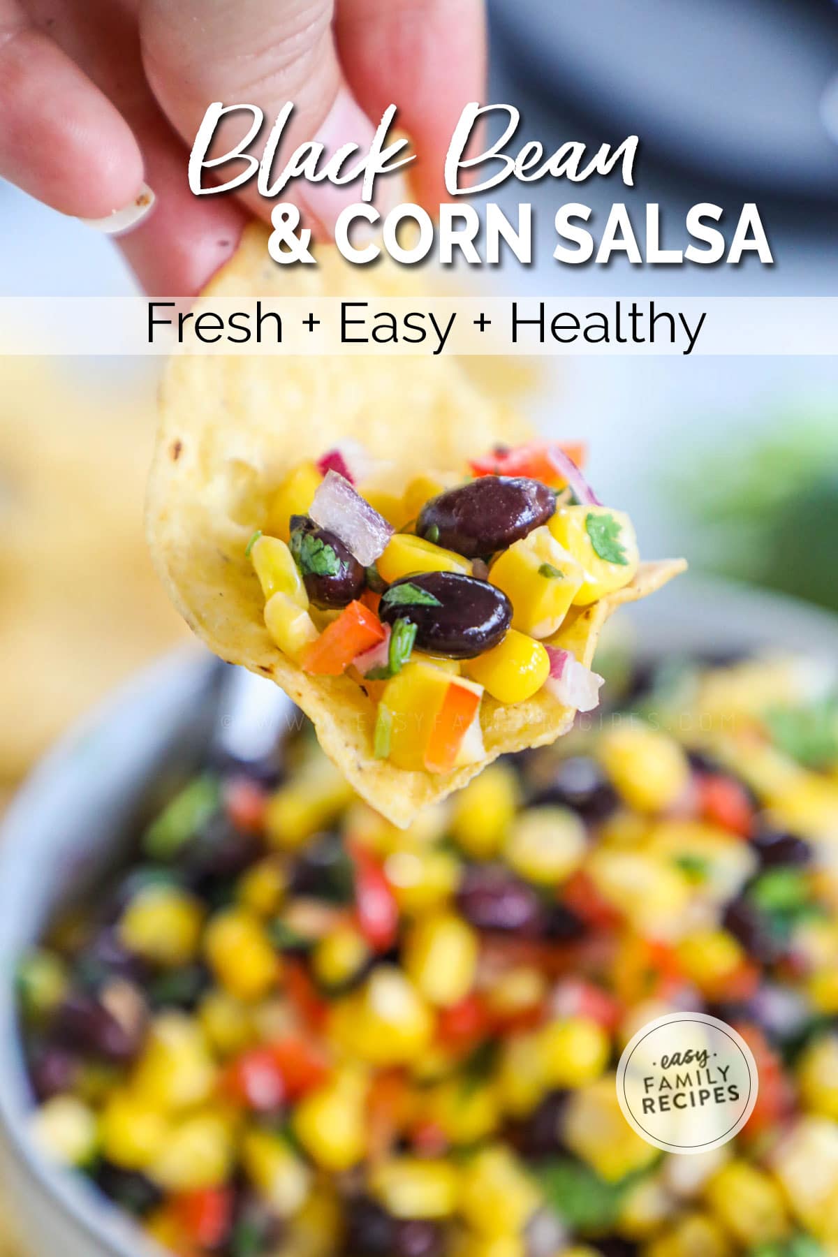 Chip scooping chunky black bean and corn salsa up to eat as a dip