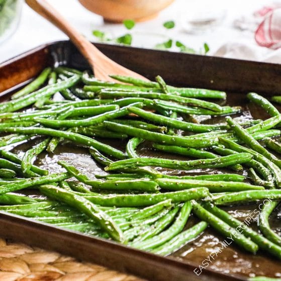 Green Beans seasoned with salt and pepper and baked in the oven on a baking sheet