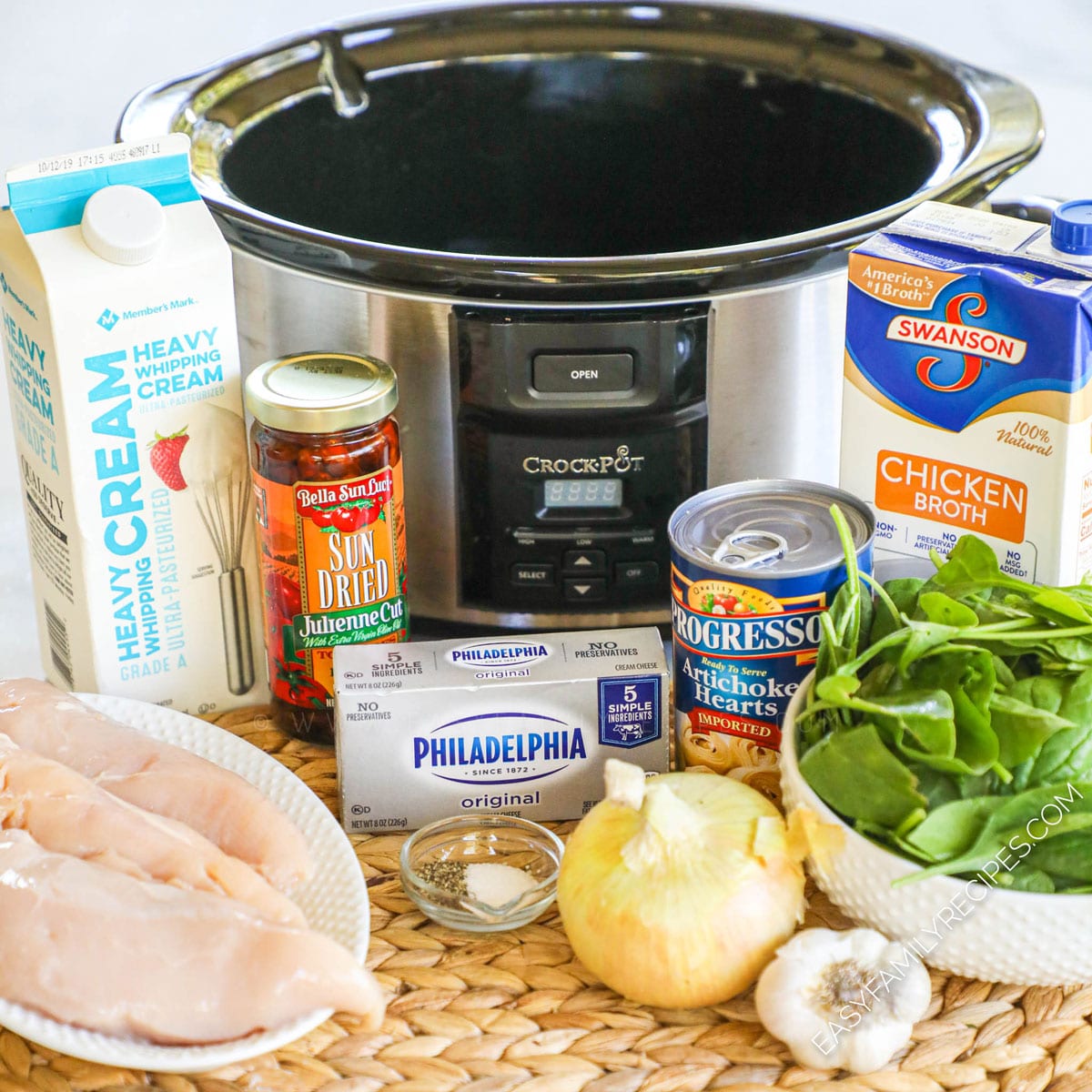 Ingredients for Tuscan Chicken Soup including chicken breast, spinach, artichokes, sun dried tomatoes, garlic, onion