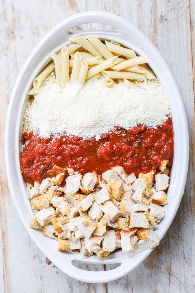 How to make chicken parmesan casserole recipe step 2: combine the pasta with the chopped chicken cutlets, marinara sauce, and cheese.