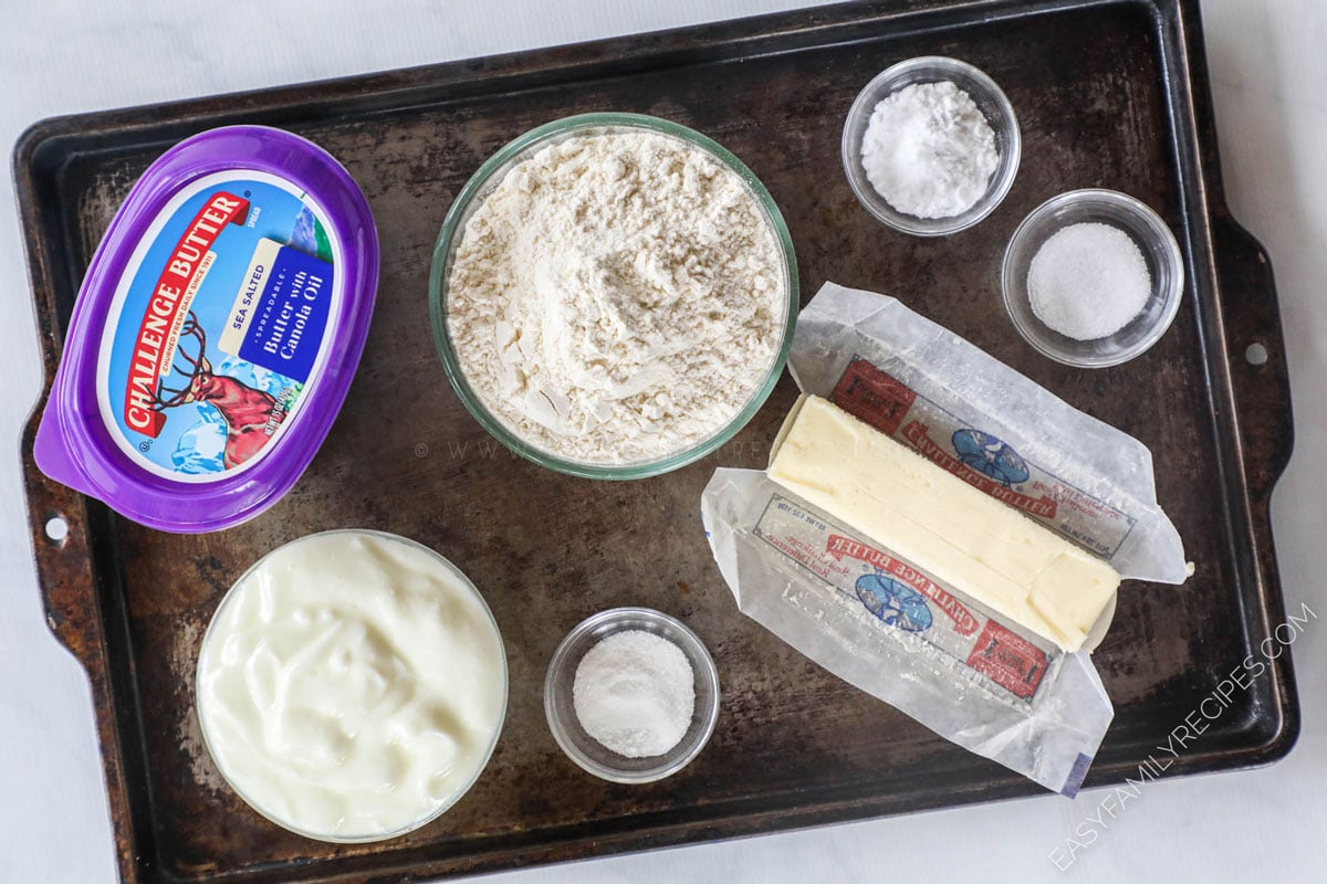 Ingredients for making No Yeast Dinner Rolls including flour, yogurt, butter, baking soda, sugar, and salt