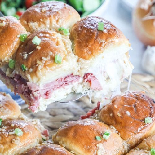 Roast Beef Sliders being lifted from a pan with a spatula