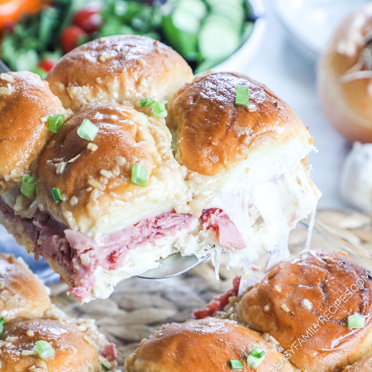 Roast Beef Sliders being lifted from a pan with a spatula