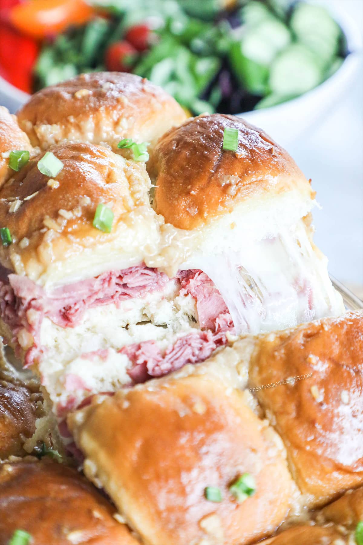Roast Beef Sliders being lifted from a pan with a spatula