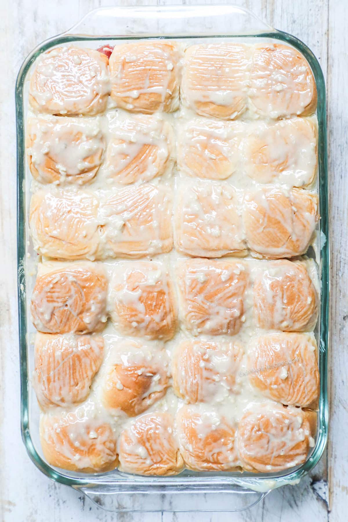 Process photos for how to make baked Roast Beef Sliders 3. Top with rolls and melted butter mixture