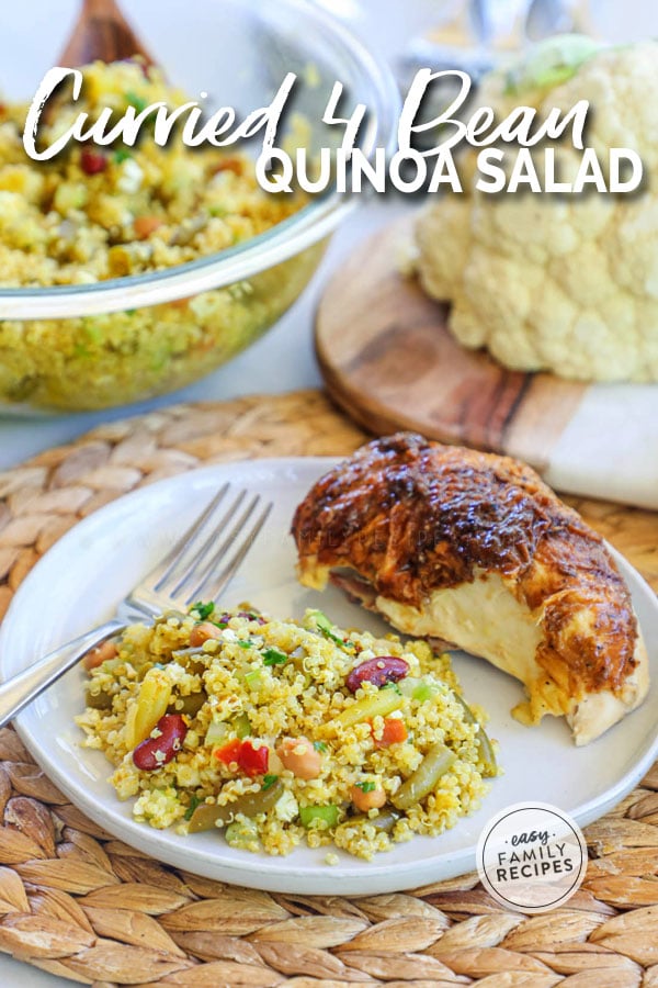 Dinner plate with 4 Bean Curry Quinoa Salad and chicken breast on it.