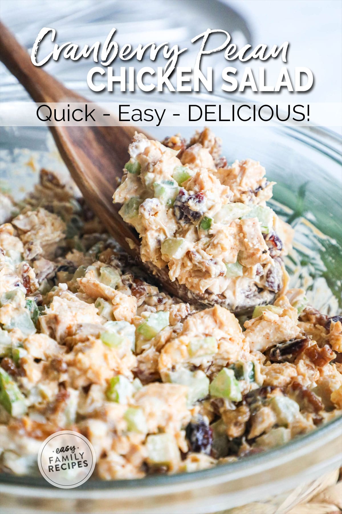 Lifting a spoonful of Cranberry Pecan Chicken salad from the bowl