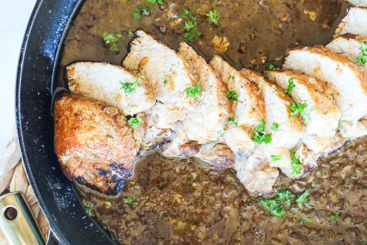 pork tenderloin in a skillet with gravy