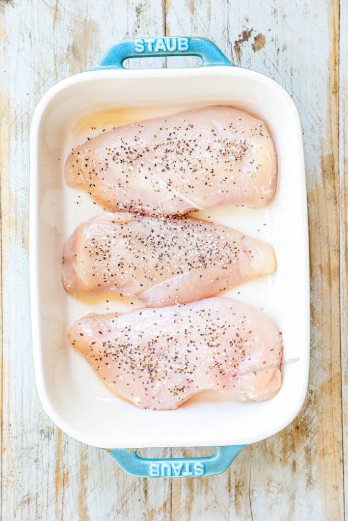 How to make cream of mushroom chicken casserole step 1: Season chicken breast and place in a casserole dish.